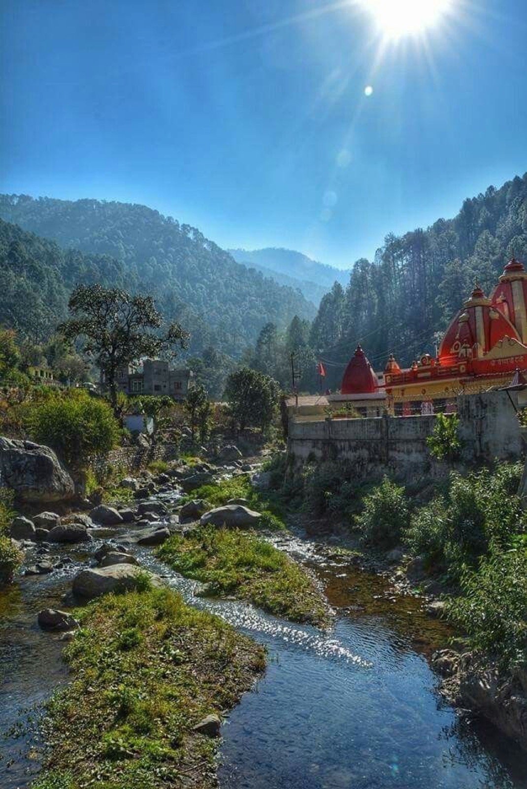 Kainchi Dham ashram with red roofs in forest